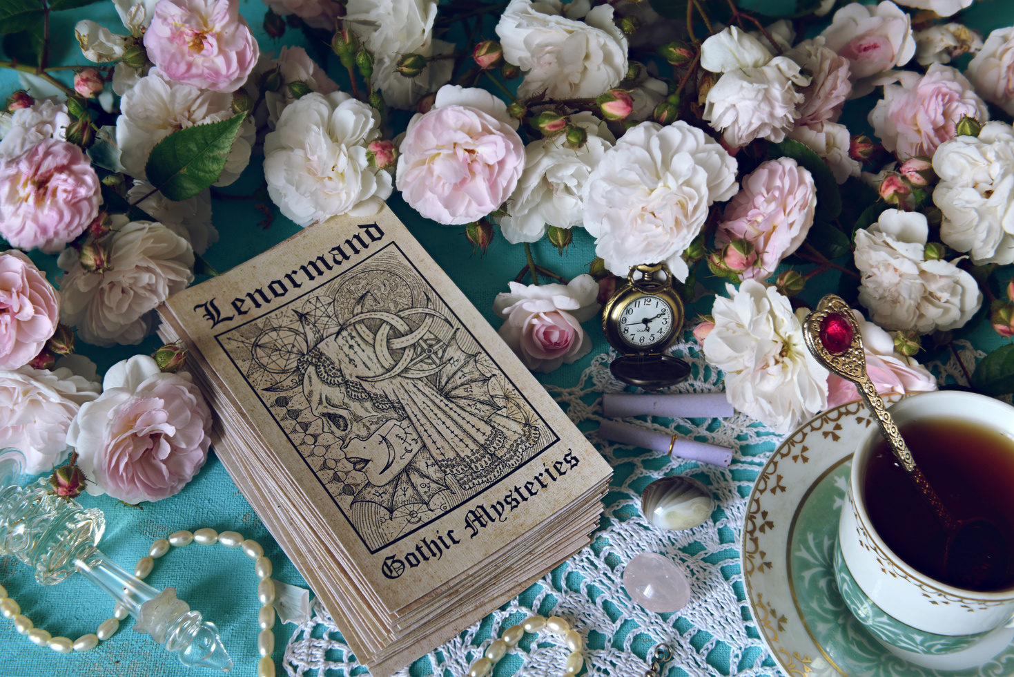 Still life with Lenormand oracle cards, cup and roses.